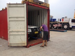 Cars being taken from container and placed on tow trucks in Singapore & trucked to Malaysian border 2 