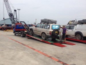 Cars being taken from container and placed on tow trucks in Singapore & trucked to Malaysian border 3 