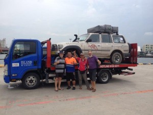 Cars being taken from container and placed on tow trucks in Singapore & trucked to Malaysian border 8 